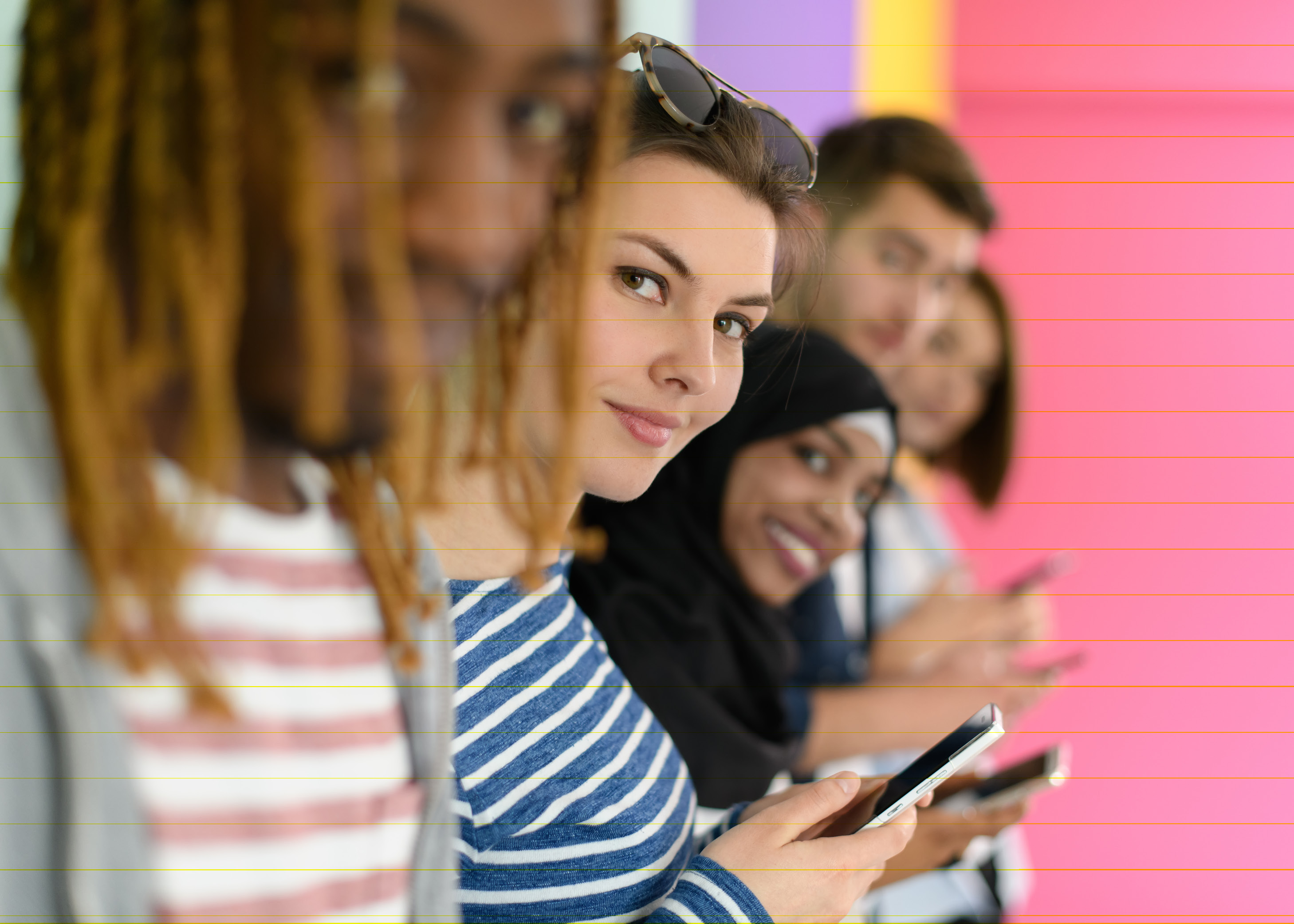 Diverse group of teenagers use mobile devices